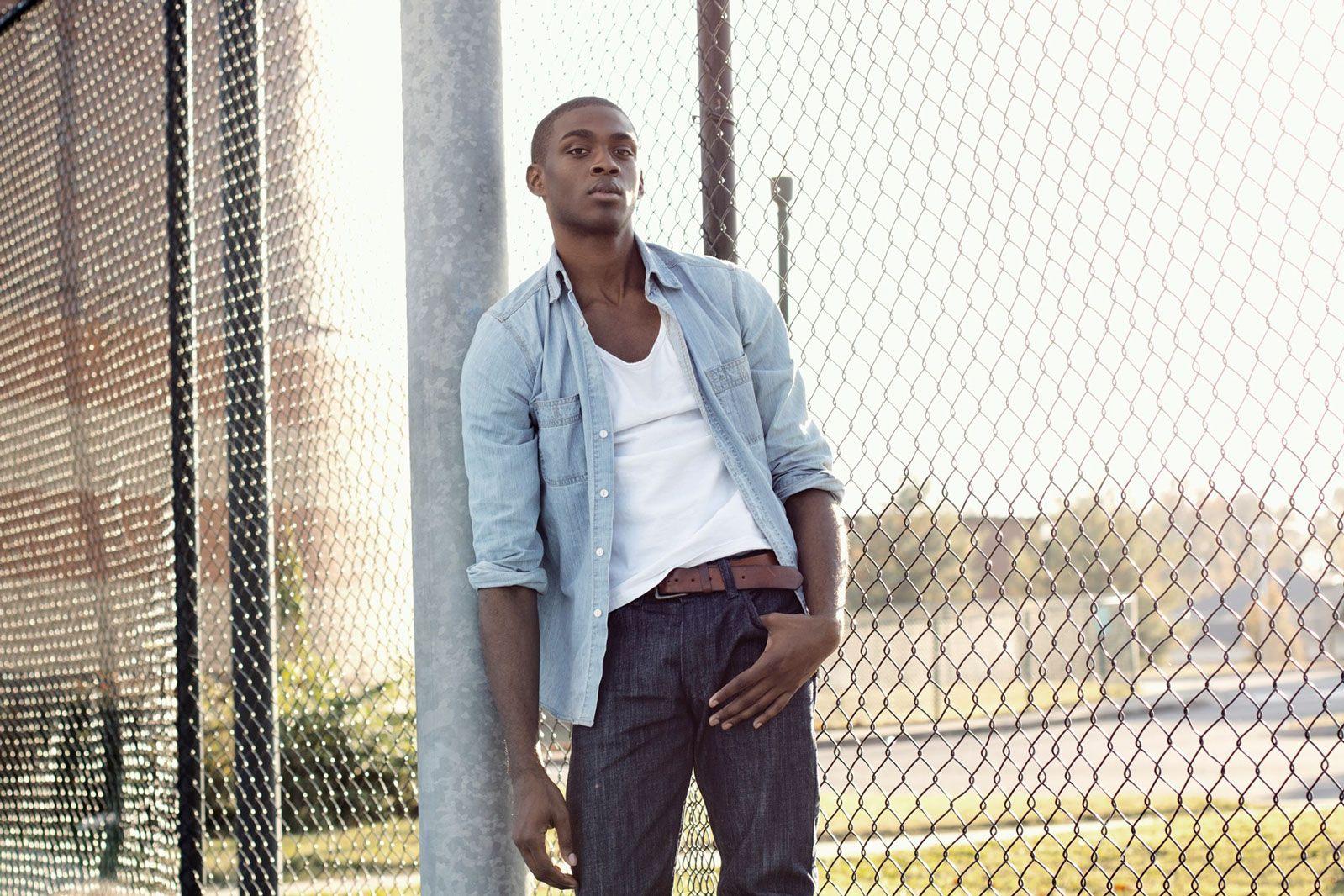 model leaning on pole