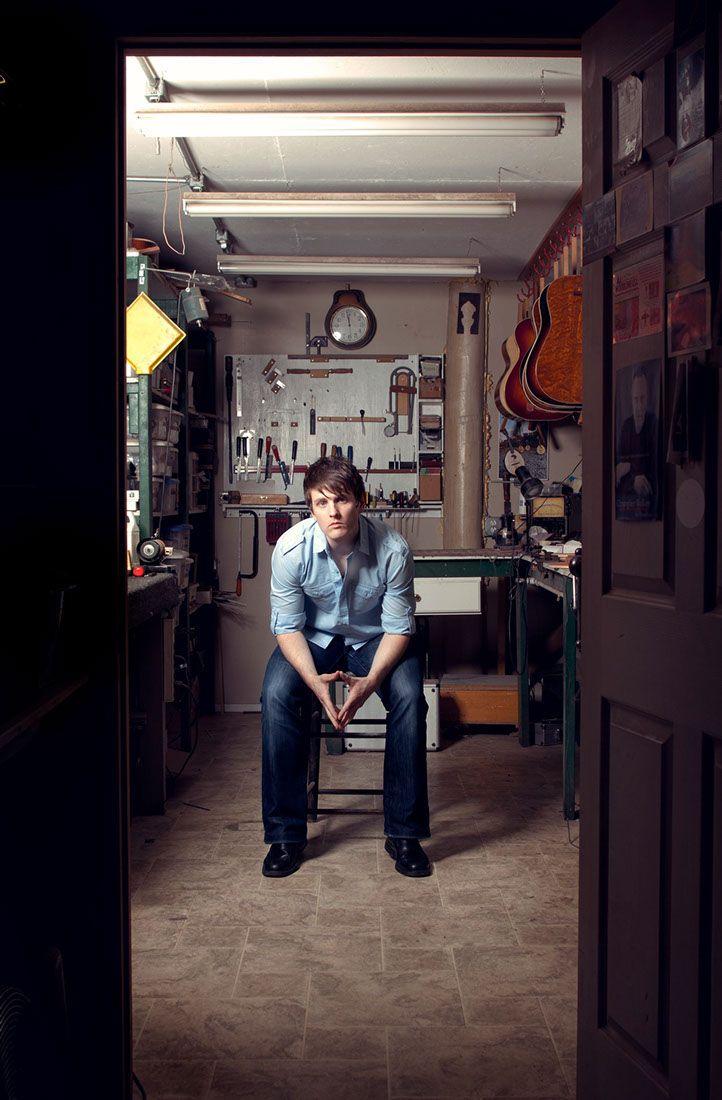 man sitting with guitars